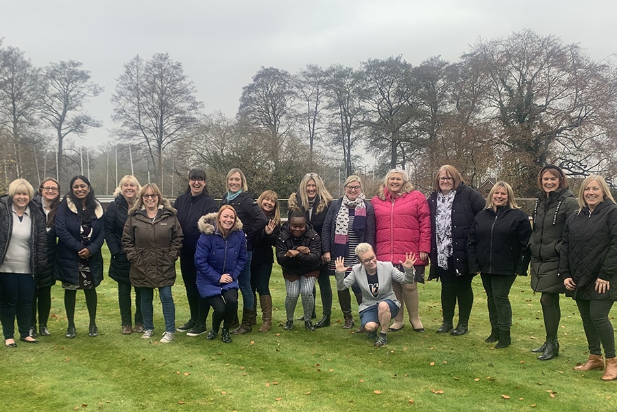 A group of people outside posing for a photo